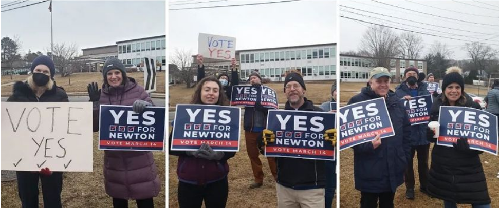 Activists holding signs for Yes for Newton